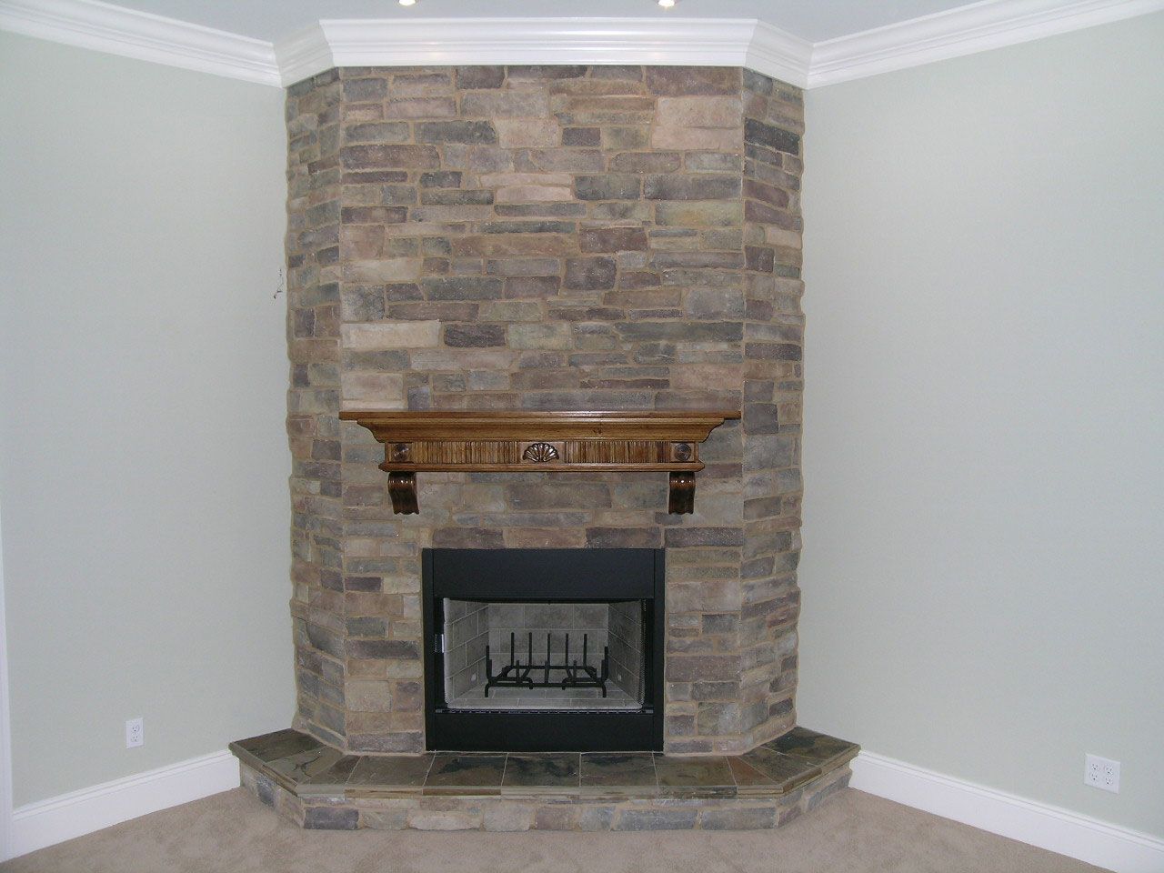 stacked stone fireplace by Acorn Fine Homes